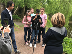 Skylar and peers use a camera and audio fo capture an interview on the New Hope Canal